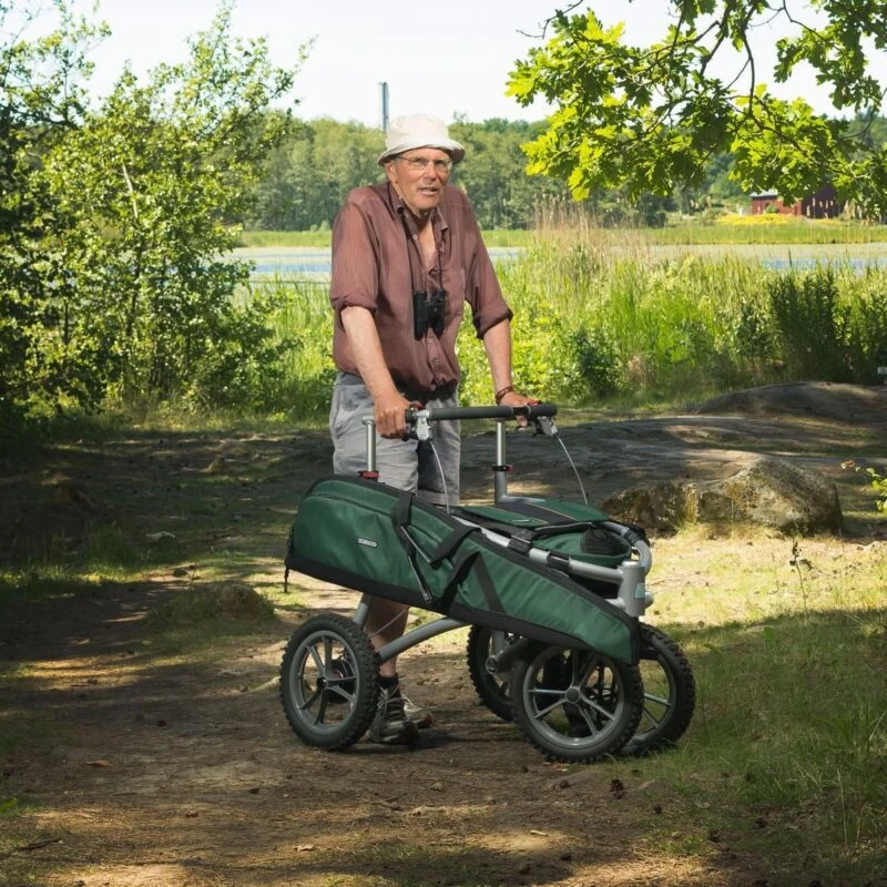 Person using a Veloped Jakt 12er walker on a forest path.
