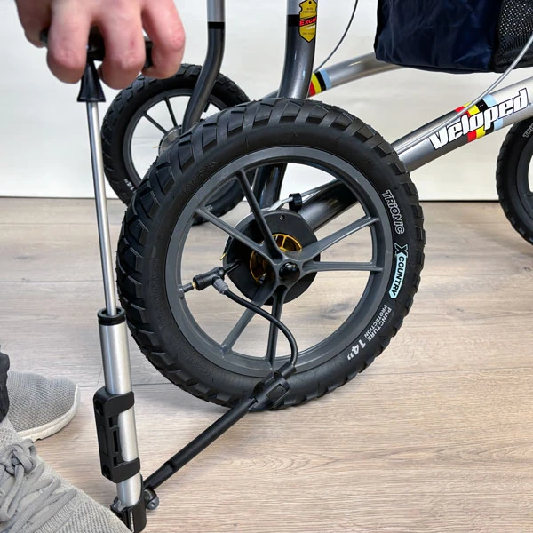 Close-up of Trionic Veloped Trek 12er wheel being inflated with a pump.
