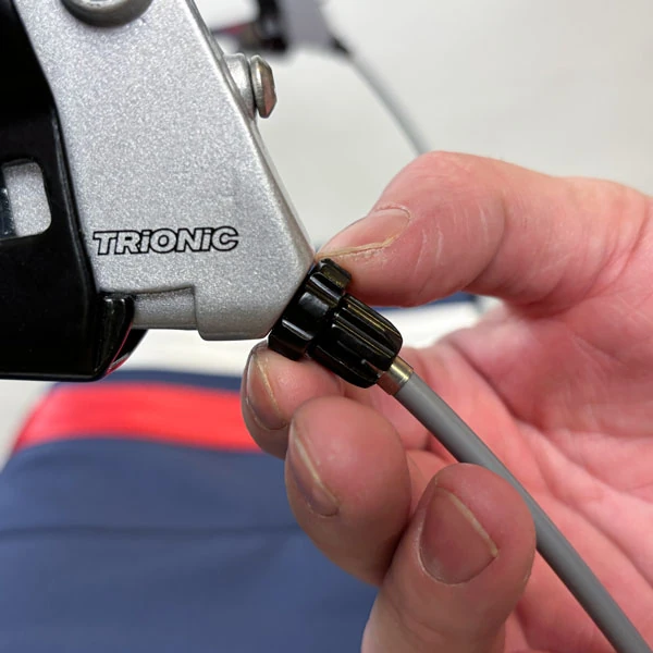 Close-up of a hand adjusting the Trionic brake lever.