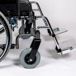 Close-up of a bariatric wheelchair's footrest and wheels.