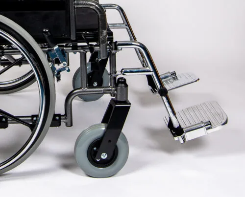 Close-up of a bariatric wheelchair's footrest and wheels.