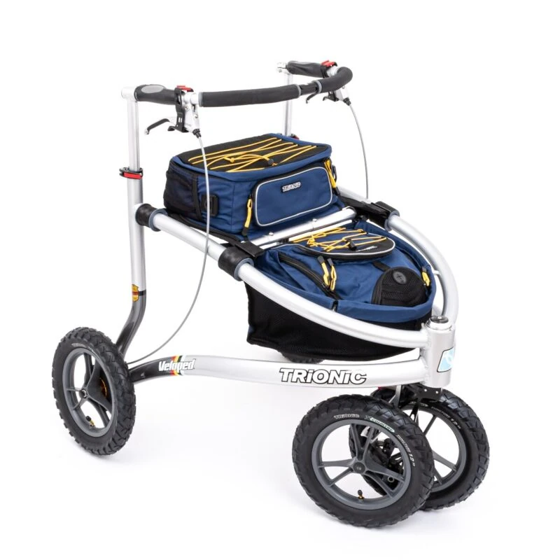 Trionic Veloped Trek 12er rollator with navy and yellow bags.