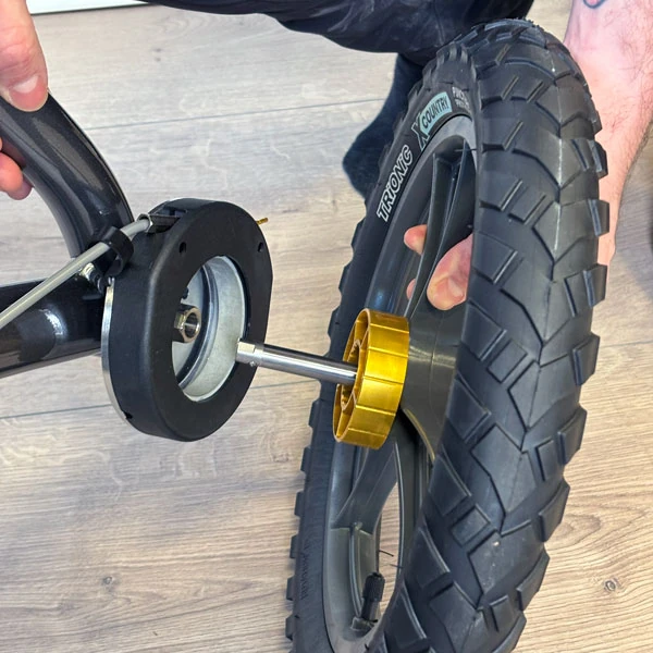 Person assembling a Trionic Veloped Trek 14er wheel.