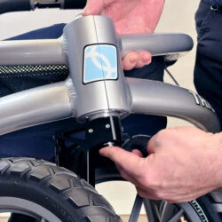 Person adjusting the wheel of a Trionic Veloped Trek 12er rollator.