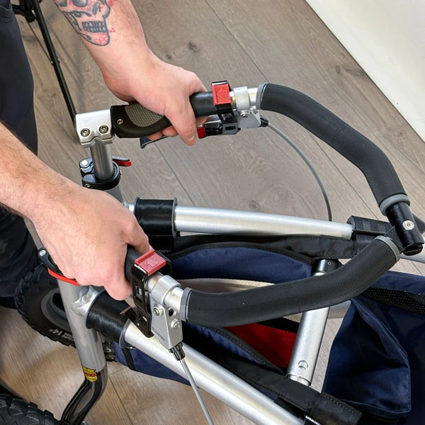 Close-up of hands adjusting the handlebars on a Trionic Veloped Trek 12er.