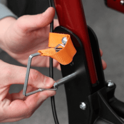 Close-up of a person adjusting the MobiWalk Upright Walker with an orange strap.