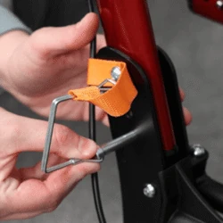 Close-up of a person adjusting the MobiWalk Upright Walker with an orange strap.
