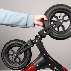 Close-up of a person adjusting the pneumatic wheels on a MobiWalk Upright Walker.
