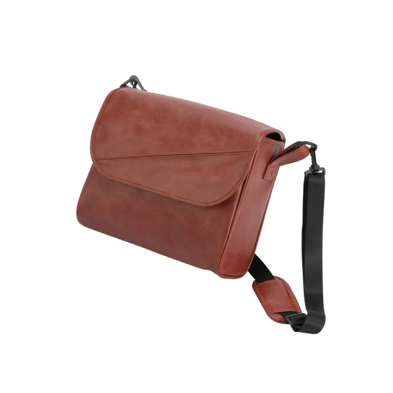 Brown leather travel bag with black adjustable strap.