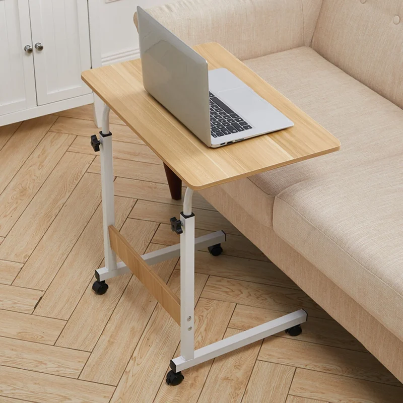 Over chair table with a laptop on it beside a beige sofa.