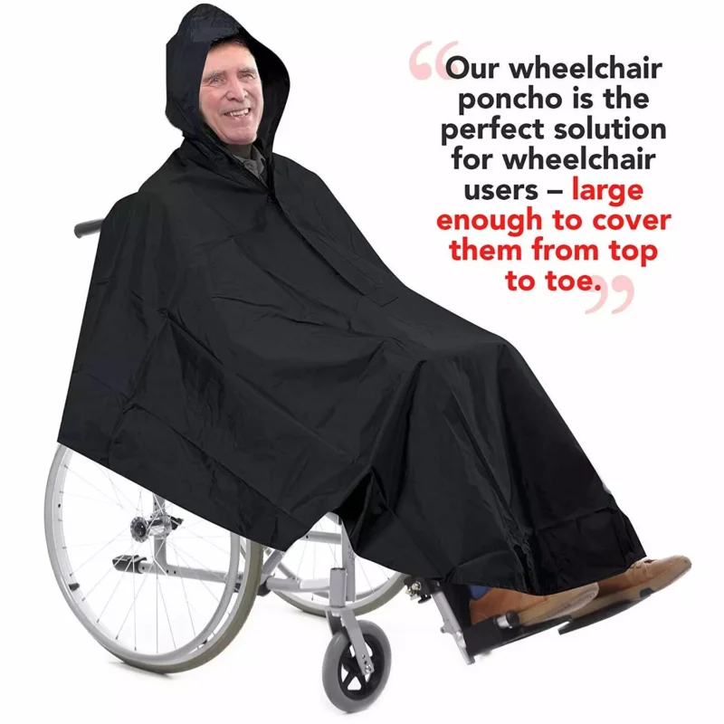 Person in a wheelchair wearing a black waterproof poncho with hood.