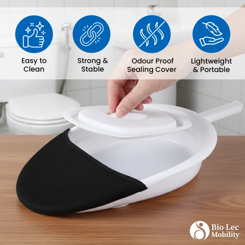 Hand lifting lid of a white bed pan with handle on wooden surface.