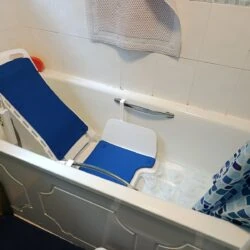Nova Bath Lift with blue seat in a bathtub.