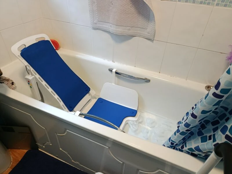 Nova Bath Lift with blue seat in a bathtub.