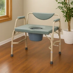 Bariatric commode chair with padded armrests and backrest in a room.