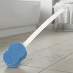 Blue sponge with long handle on wet bathroom floor.