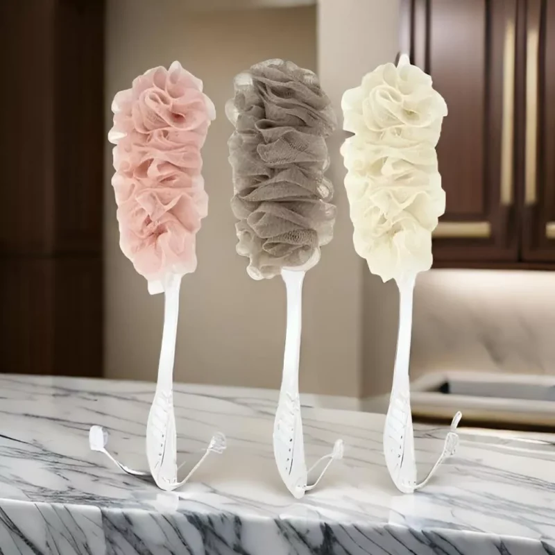 Three long handle bath brushes with soft mesh sponges in pink, brown, and cream.