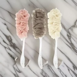 Three long handle bath brushes with soft mesh sponges in pink, brown, and cream.