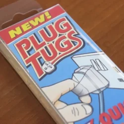 Plug Tugs packaging with illustration of a hand pulling a plug.