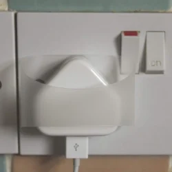 Plug Tugs Puller attached to a plug in a wall socket.