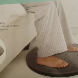 Person standing on a transfer turntable near a bed.