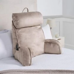 Cuddle Cushion lumbar support pillow in mink color on a bed.