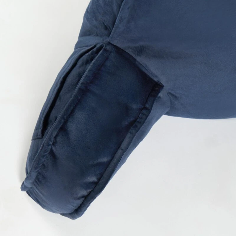 Close-up of navy lumbar support pillow with soft velvet fabric.