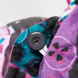 Close-up of colorful velvet fabric with a button detail.