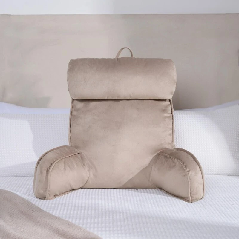 Mink lumbar support pillow with arms on a white bed.