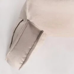 Close-up view of a beige lumbar support pillow.