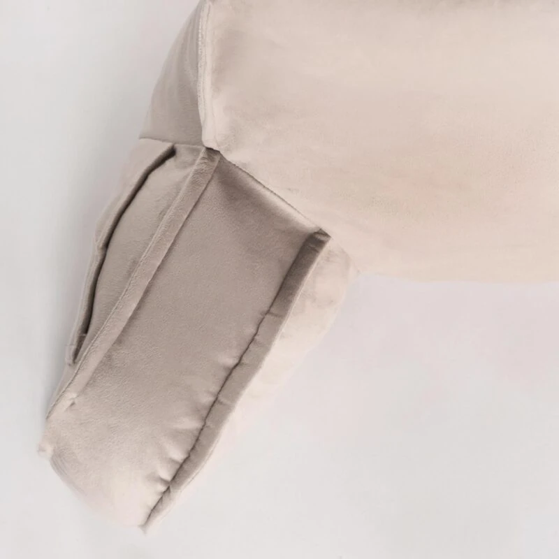 Close-up view of a beige lumbar support pillow.