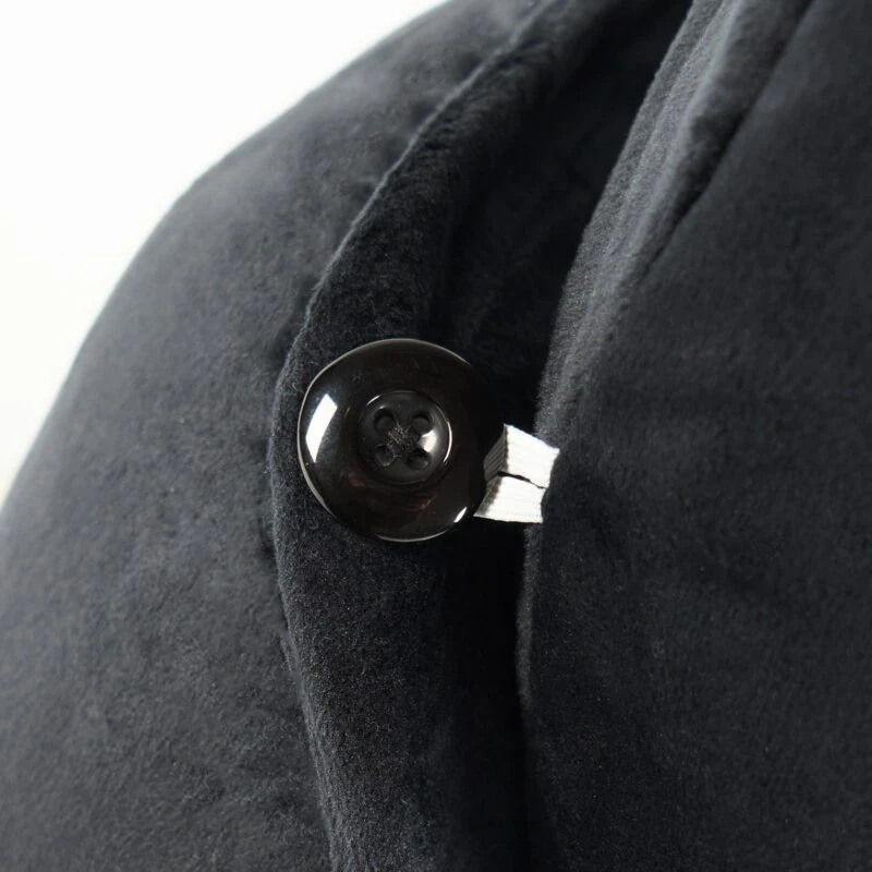 Close-up of a black button on a Cuddle Cushion.