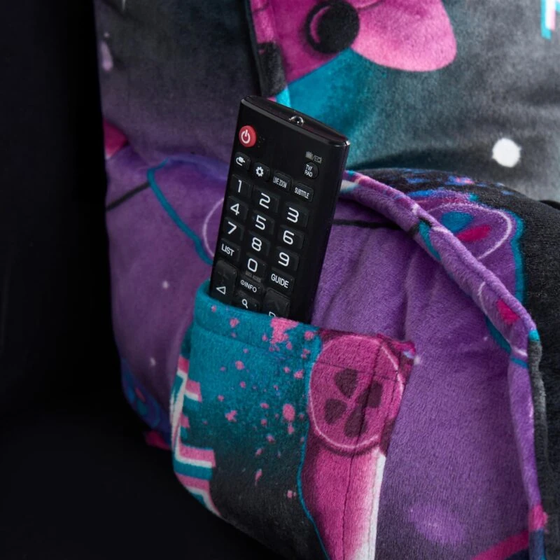 Close-up of a colorful pillow with a remote control in its pocket.