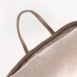 Close-up of the handle on a velvet cushion.