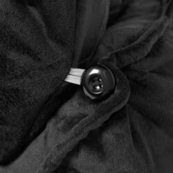 Close-up of black matte velvet fabric with button detail on lumbar support pillow.