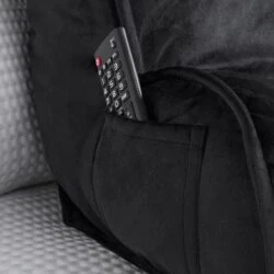 Black lumbar support pillow with a remote control in its pocket.