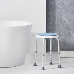 Height adjustable shower stool with blue seat next to a bathtub.