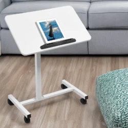 White over bed table with a tablet on it, in a living room setting.
