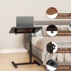 Over bed table tray beside a bed with a laptop on it.
