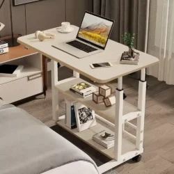 Height adjustable over bed table with a laptop, phone, and books.