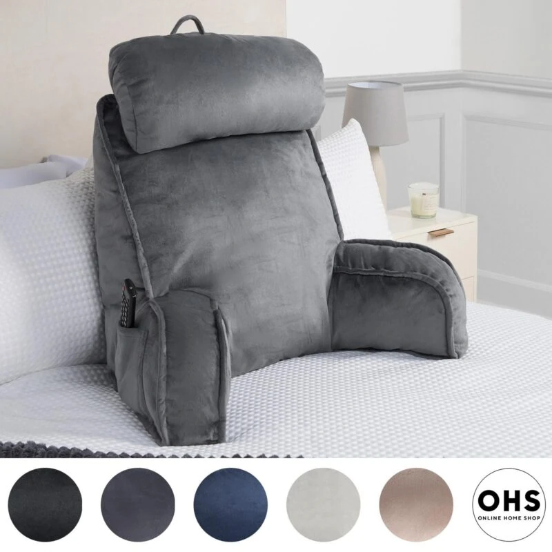 Grey lumbar support pillow with headrest and arms on a bed.