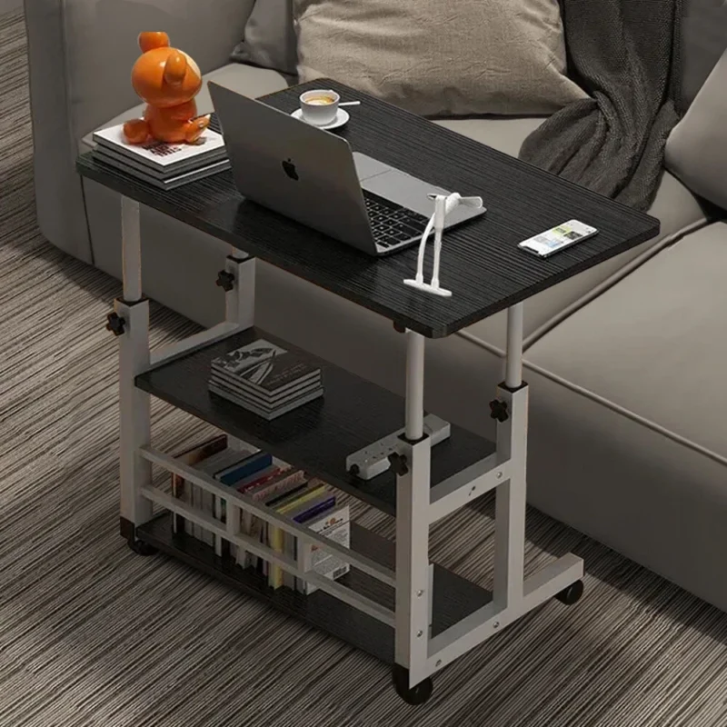 Black over bed table with laptop and shelves, next to a sofa.