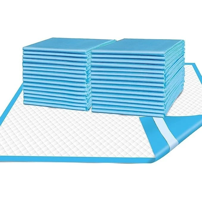 Stacked blue disposable incontinence bed pads with one pad unfolded showing quilted surface.