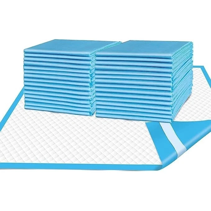 Stack of blue disposable incontinence bed pads with one unfolded showing quilted surface.