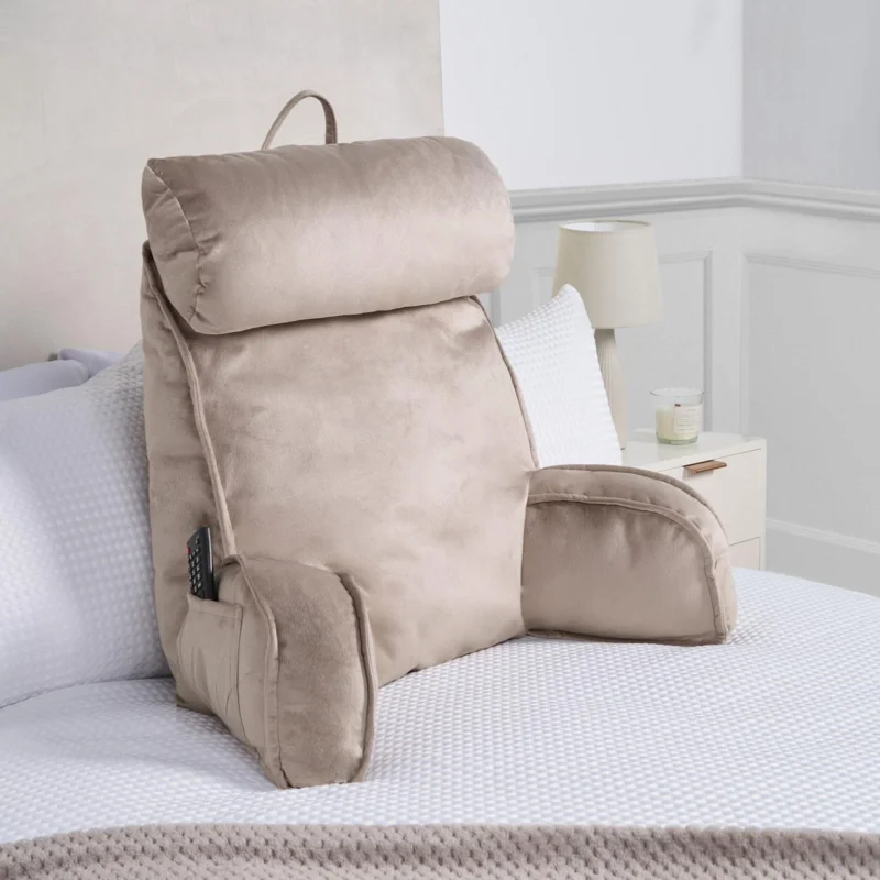 Cuddle Cushion lumbar support pillow with soft arms on a bed.