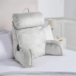 Silver Cuddle Cushion with headrest and arms on a bed.
