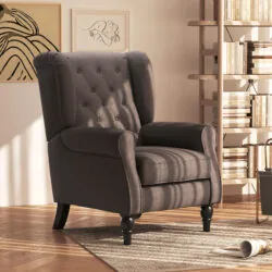 Dark grey retro wingback armchair with tufted back in a cozy living room setting.