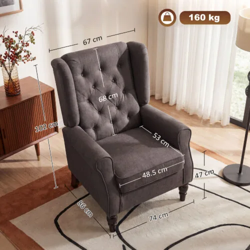 Grey wingback armchair with visible dimensions in a living room setting.