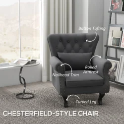Dark grey Chesterfield-style accent chair with pillow in a living room.