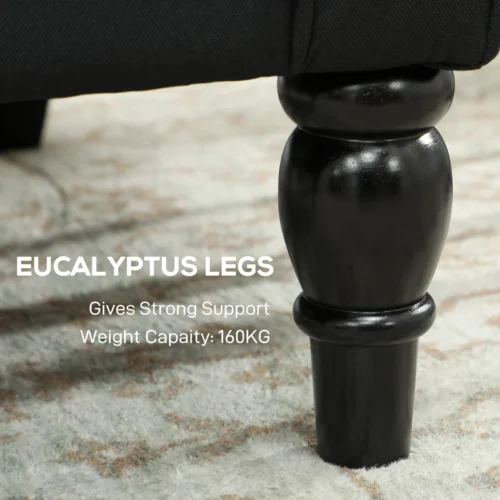 Close-up of black wooden leg of armchair on carpet.
